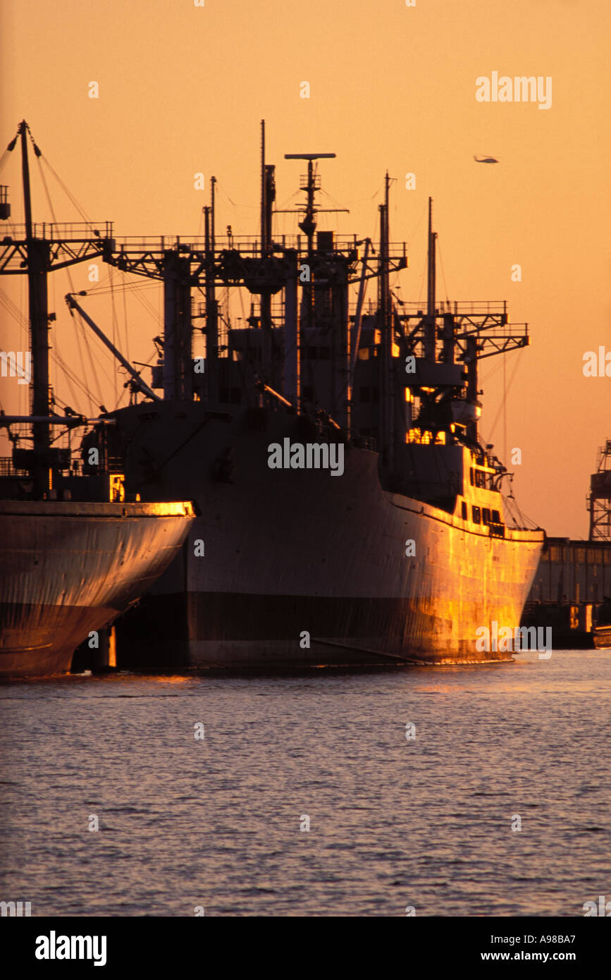 California, Oakland, Freighters at sunset in Inner Harbor Stock Photo