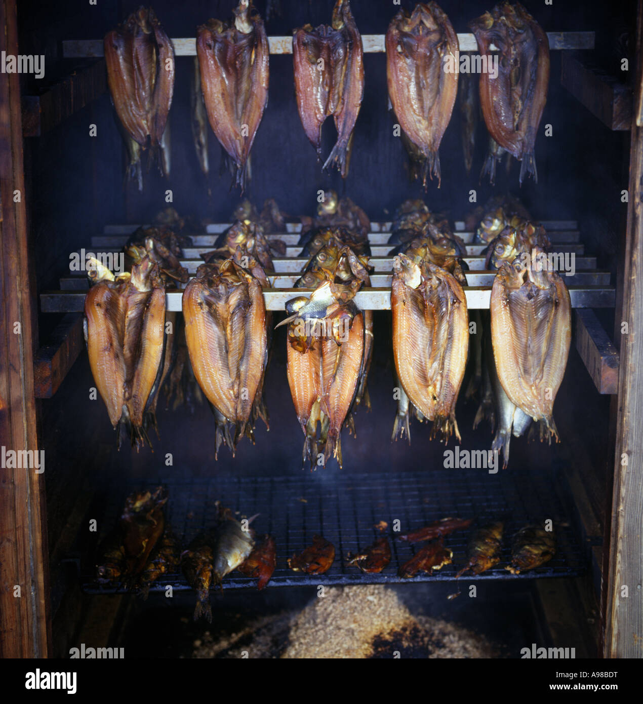 herring or kippers being smoked in racks Stock Photo - Alamy