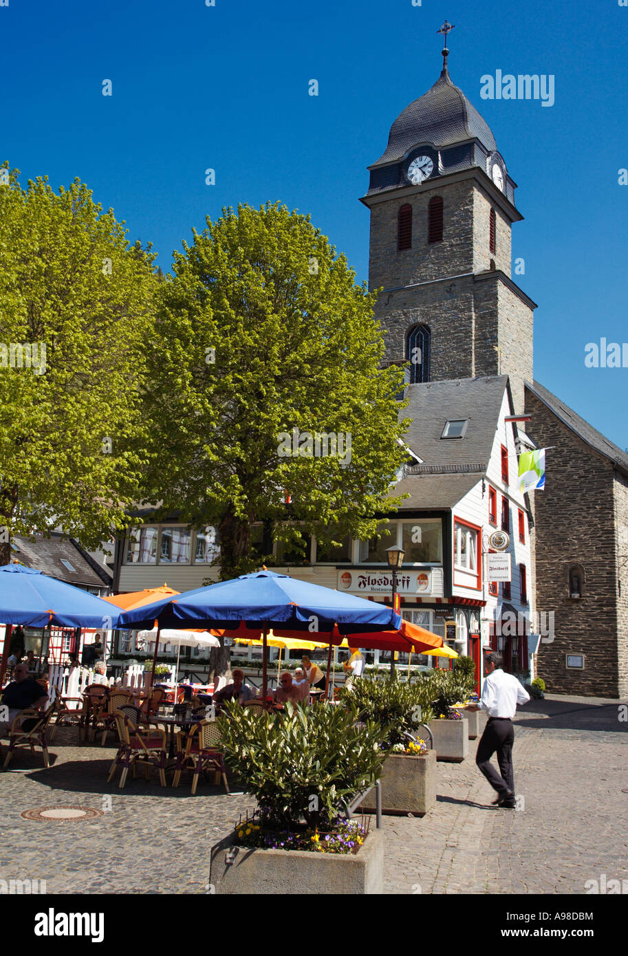 Church and pavement cafe scene in Monschau, Eifel Region, Germany, Europe Stock Photo