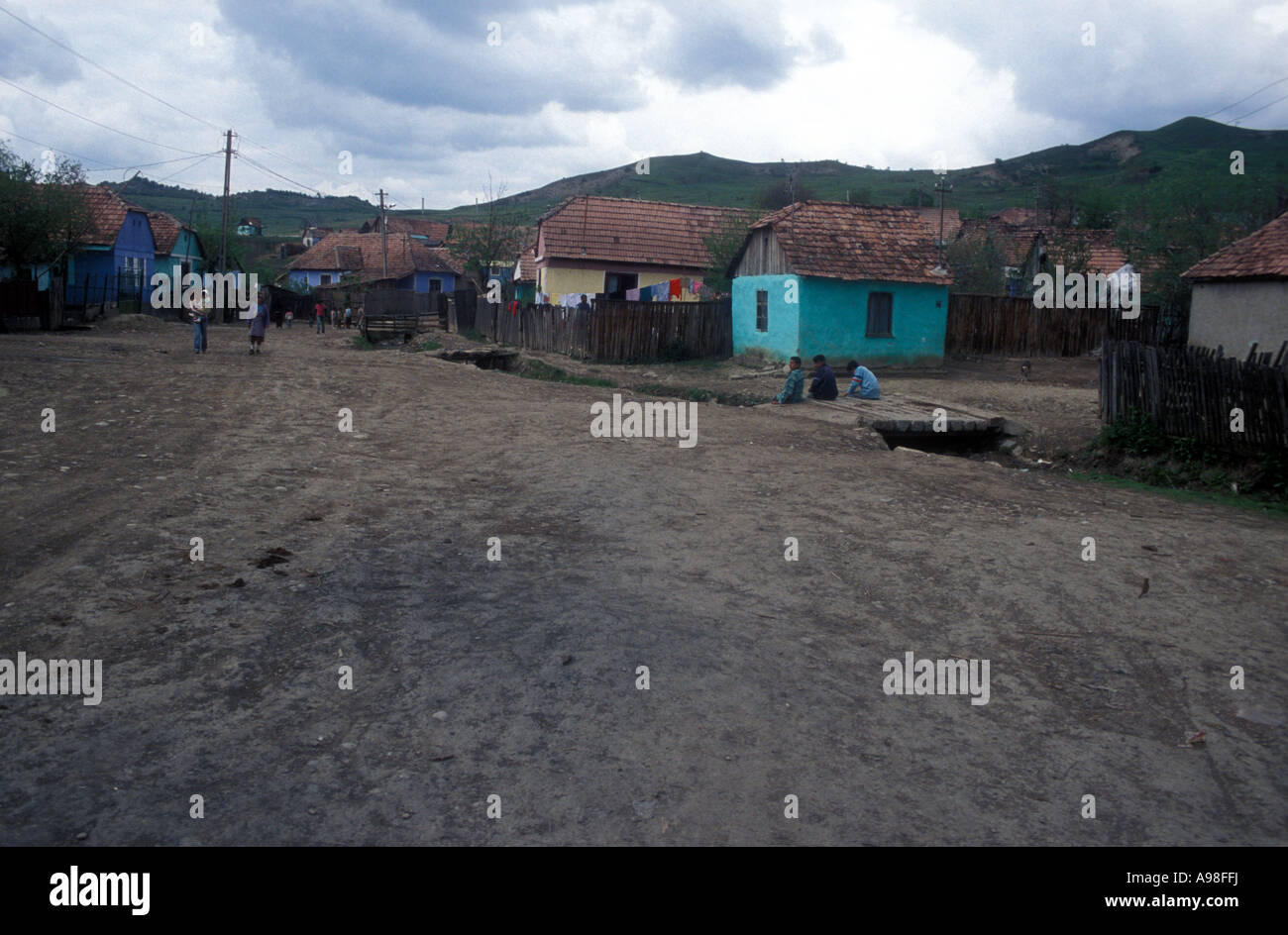 Overview of Transylvanian Gypsy village showing large dirt street and