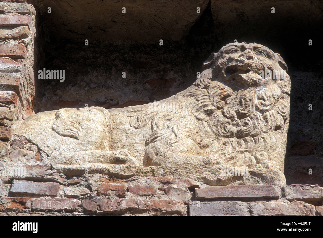 An ancient, crumbling  stone lion in the courtyard of Castel Bethlen at Cris, Romania. Stock Photo