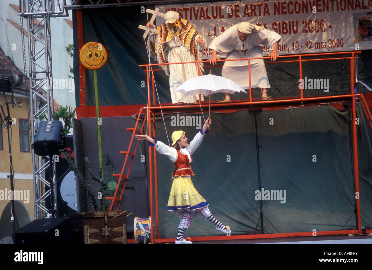 A woman acts as a marionette during a show in Sibiu, Romania. The string  pullers and the stage are also shown Stock Photo - Alamy