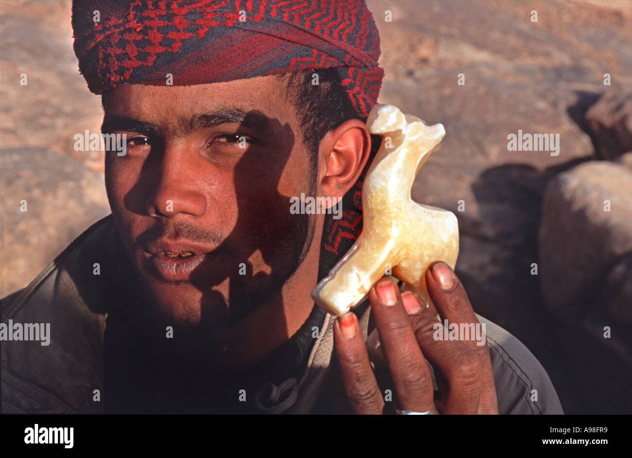 Bedouin vendor selling from his stall on the summit of Mount Sinai Popular hike for pilgrims and tourists alike Holy land, Egypt Stock Photo