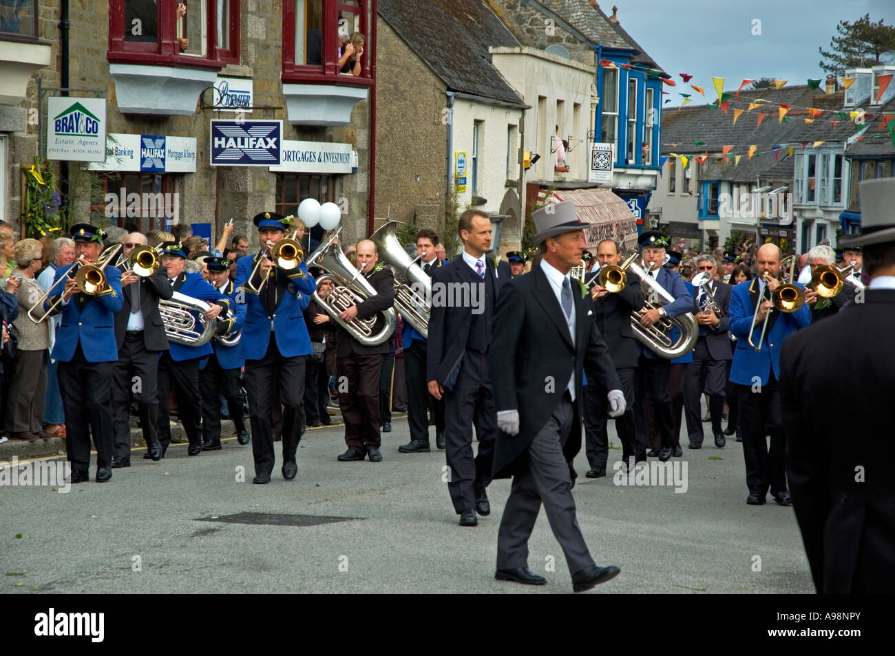 the local silver band marching through the streets of helston,cornwall,england on the annual flora day celebrations Stock Photo