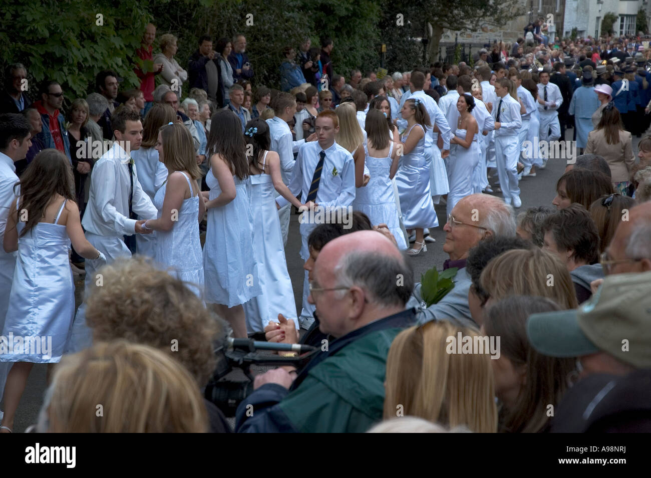 the local people of cornwall,england dancing through the streets of helston,cornwall,england on the annual flora day celebration Stock Photo