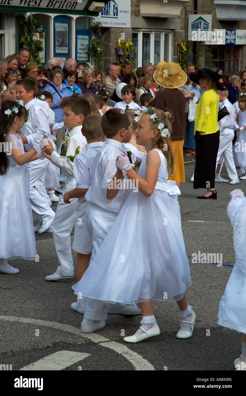 the local children dancing in the streets of helston,cornwall,england on the annual flora day celebrations Stock Photo