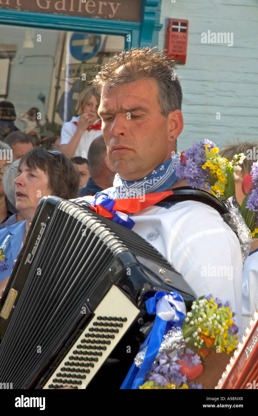 man playing a piano accordion on obby oss day in padstow,cornwall