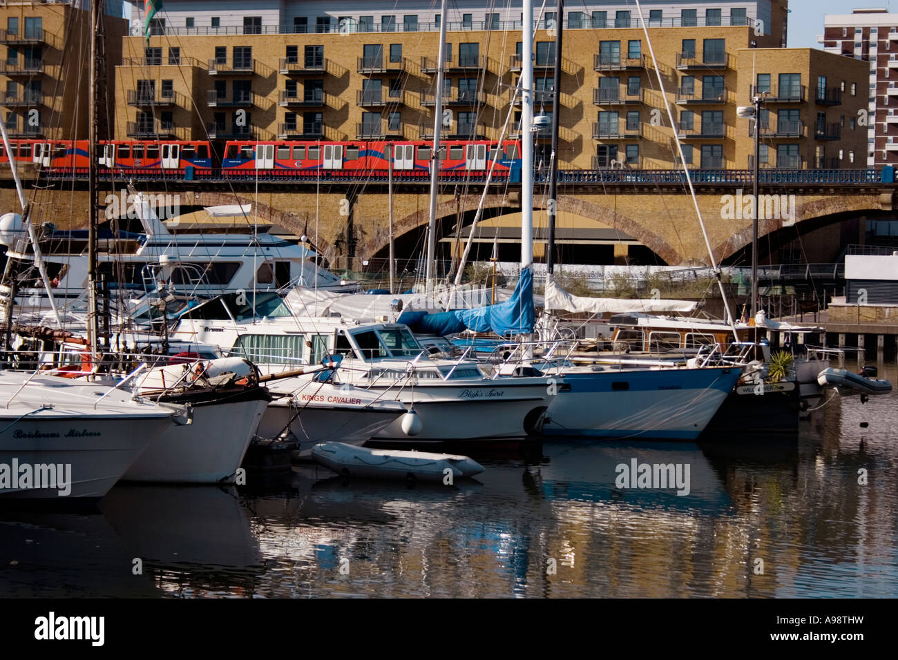 LIMEHOUSE YACHTS, at Limehouse Marina, with a DLR train crossing  bridge in background. Stock Photo