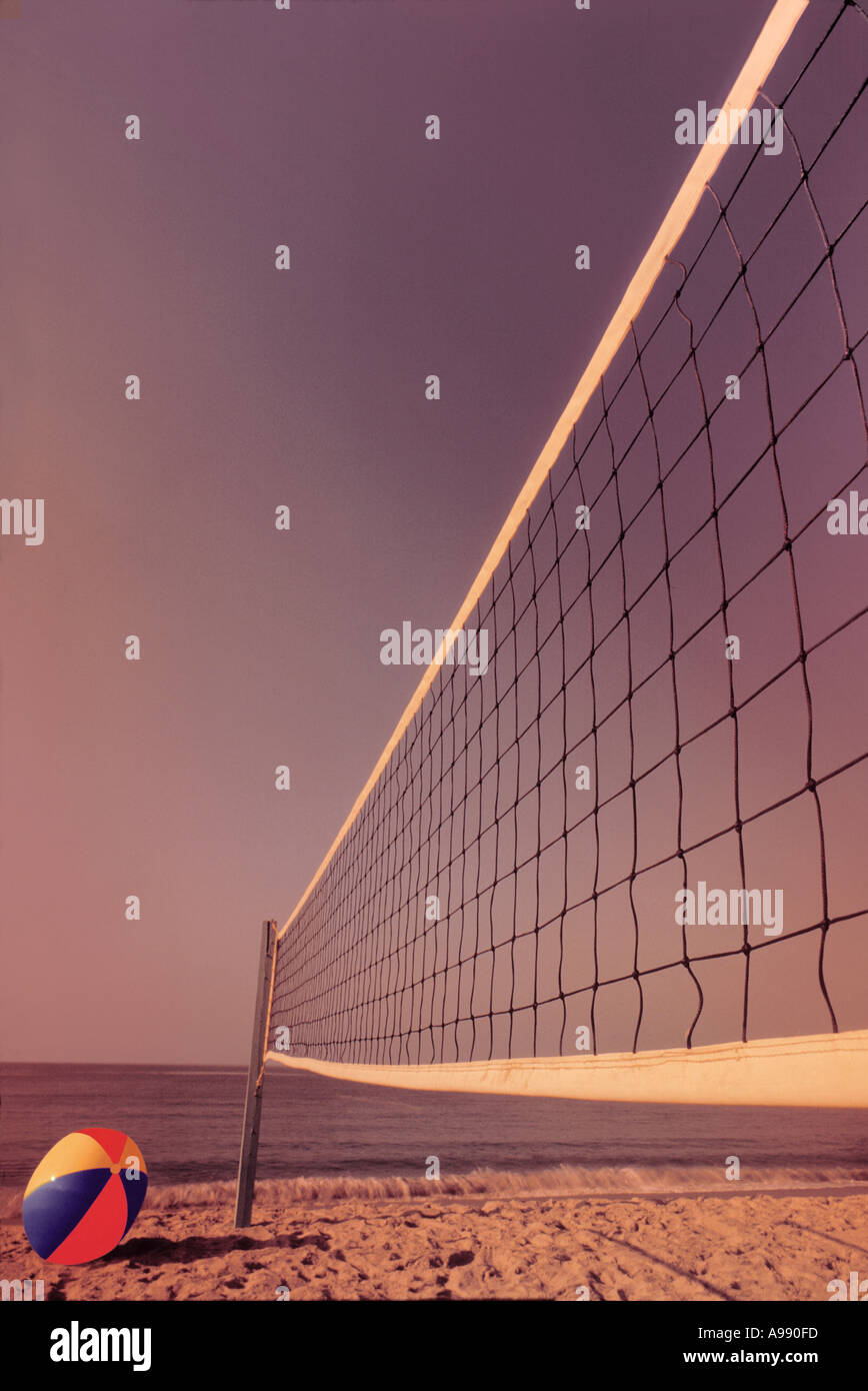 Volleyball net and beachball on beach. Stock Photo