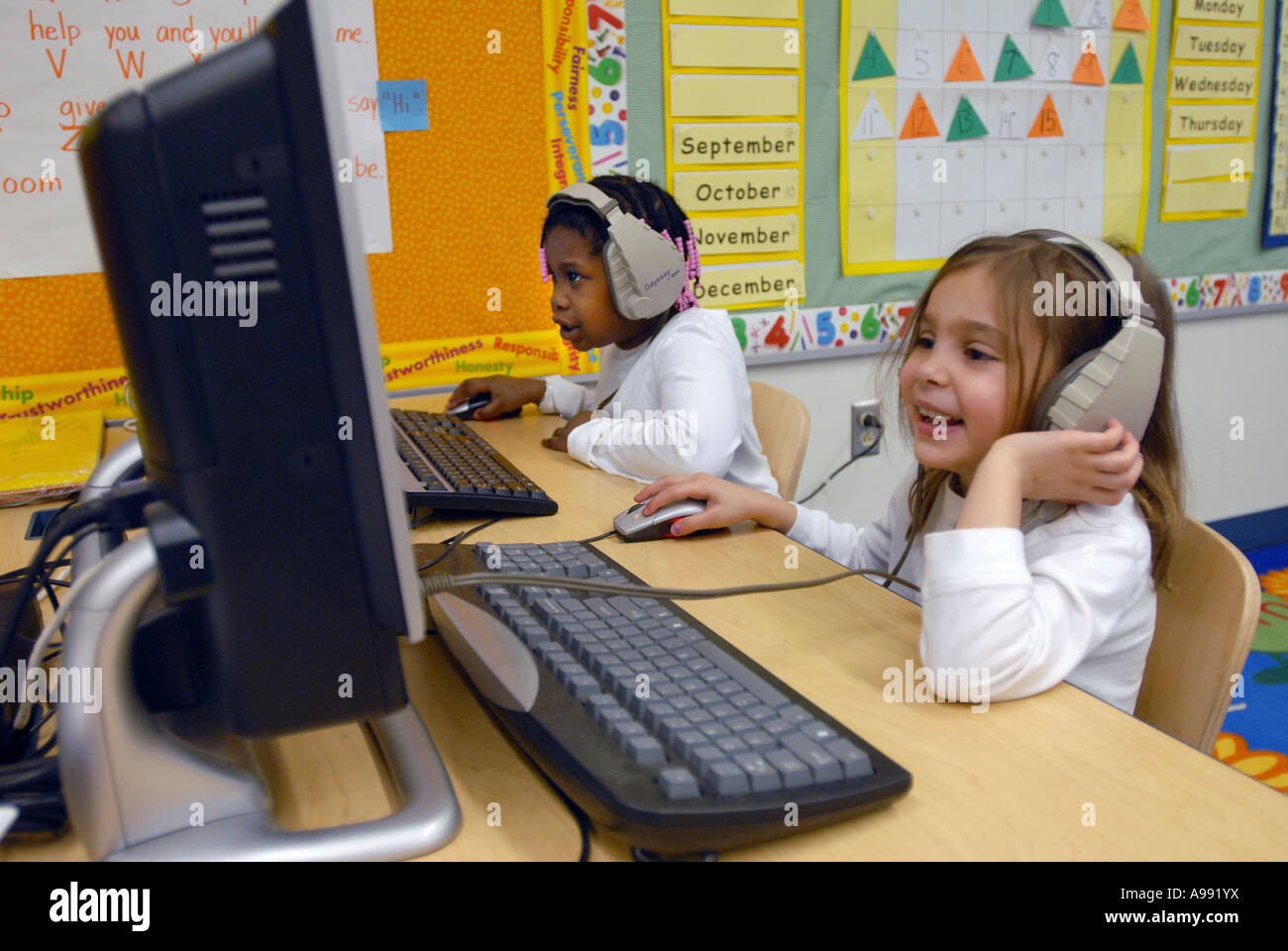 School Children use computers with headphones to learn language in ...