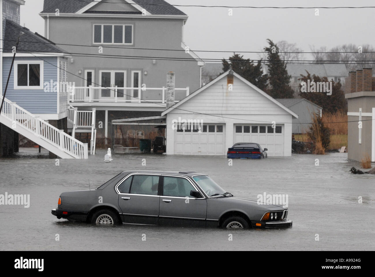 A flooded car during a storm Stock Photo