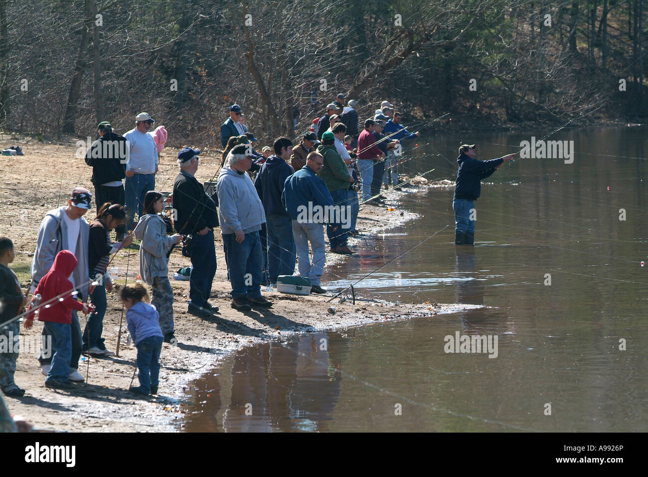 People crowd the shores of a Connecticut Pond on the first day of