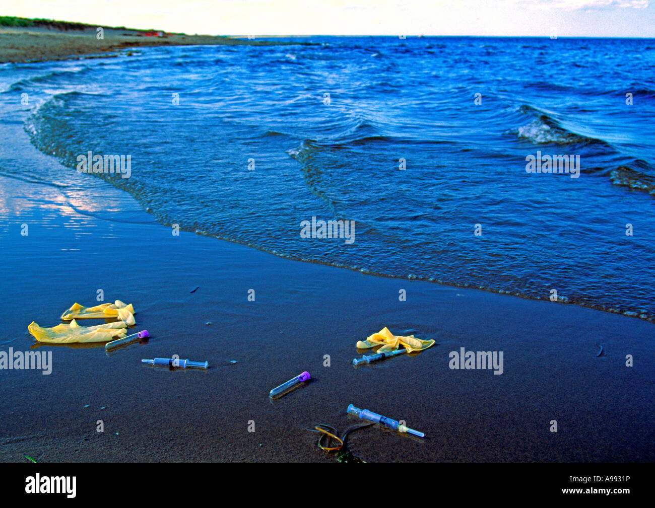 medical waste washed up on a beach Stock Photo