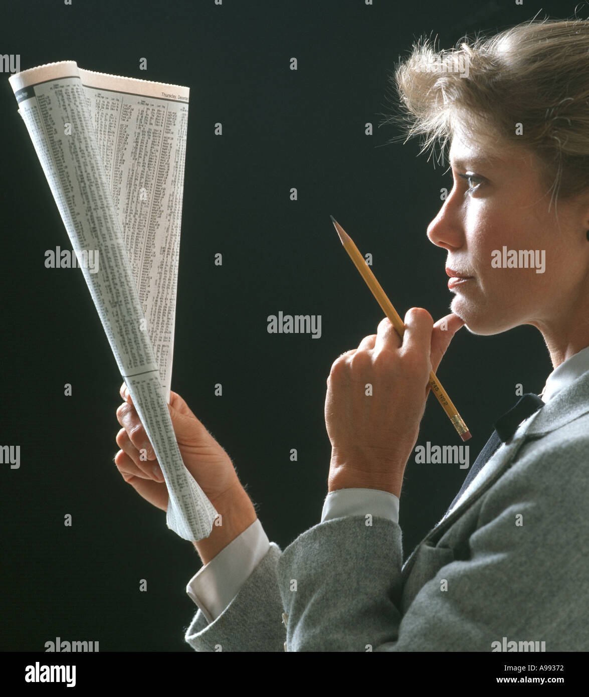 businesswoman studying stock prices in office Stock Photo