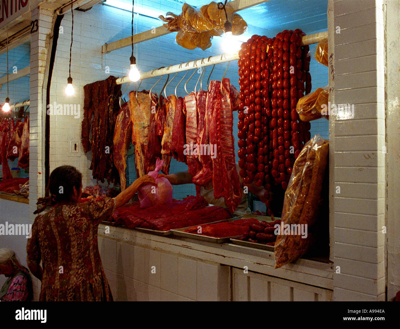 Female customer making purchase in Oaxacan Meat Market Mexico Stock