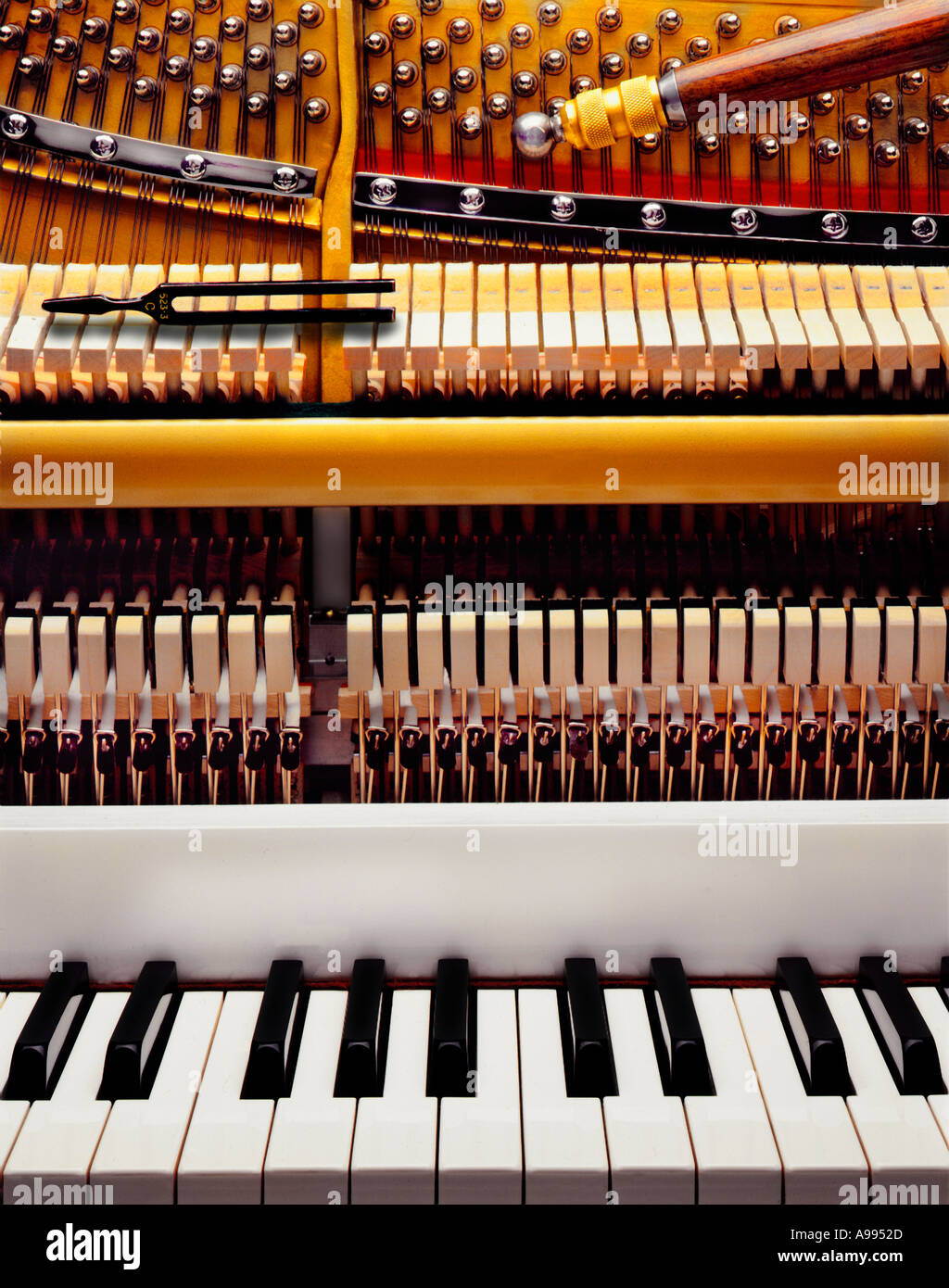 A piano keyboard and the inner workings and mechanisms of a piano Stock