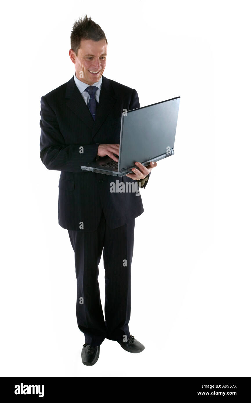 Businessman entering some information on a laptop computer Stock Photo