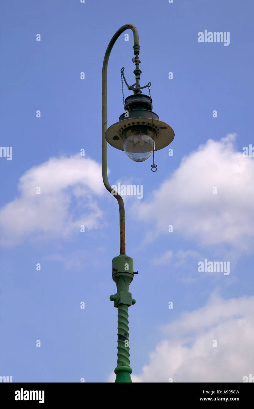 Old gas powered lamp post against blue sky Stock Photo