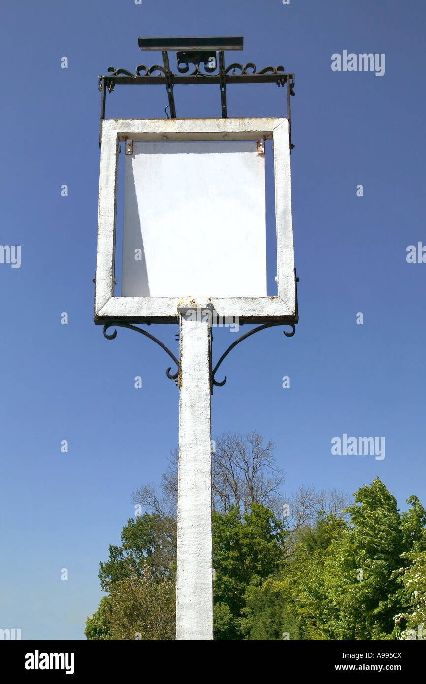 An old English pub sign against a blue sky blank for your own image ...