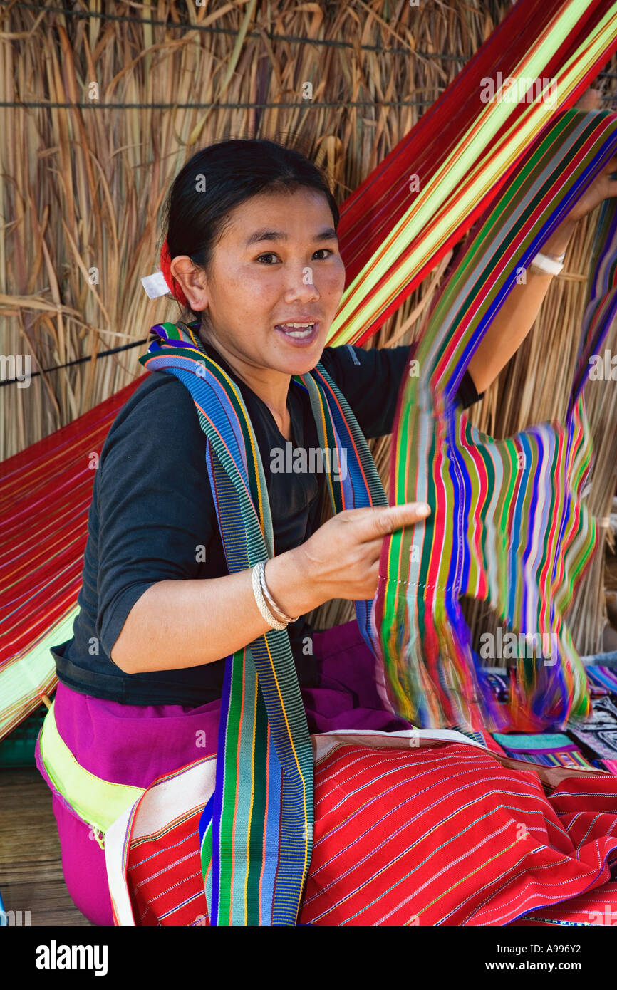 Young lady from the Karen Hill Tribe displaying her scarves she sells to supplement her family s income Stock Photo