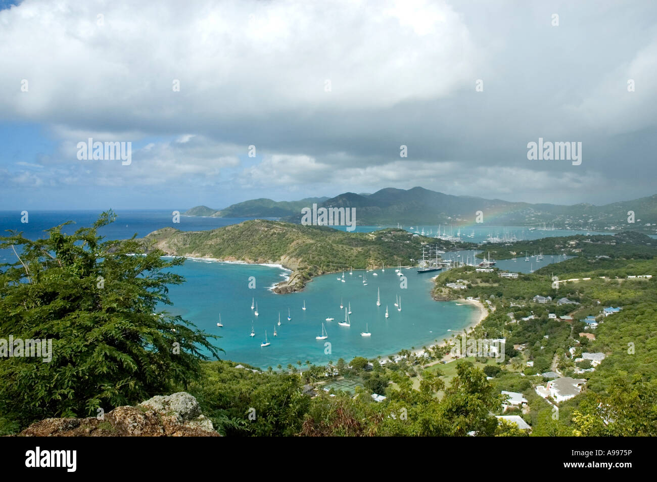 The calm blue waters of English Harbour dotted with white yachts as seen from The Lookout, Shirley Heights, Antigua Stock Photo