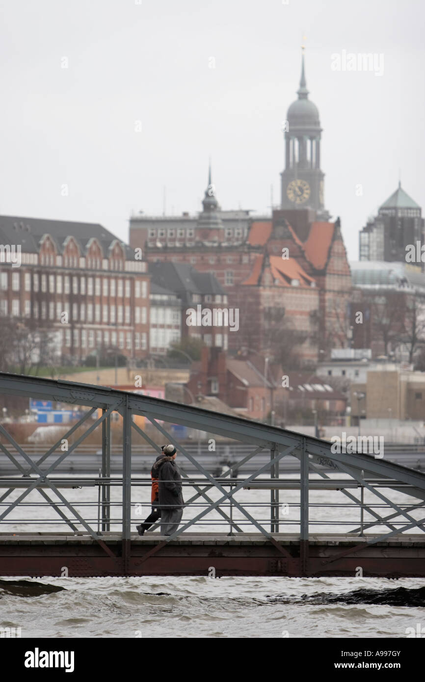 Germany, January 13, 2007. Pedestrians walk on a bridge past floods at traditional fish market area Fischmarkt in Hamburg Stock Photo
