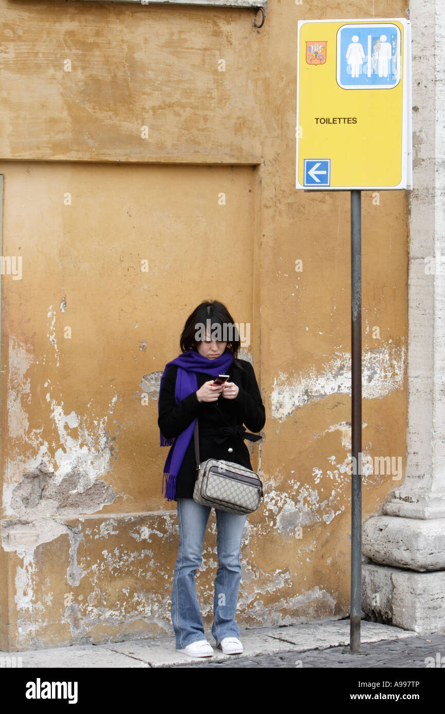 Japanese tourist writes a SMS in Rome, Italy Stock Photo