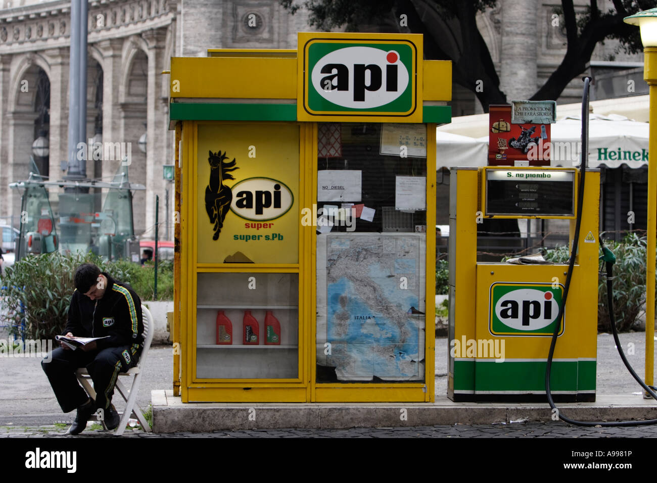 API gas station attendant waits for for customers to pull up to the