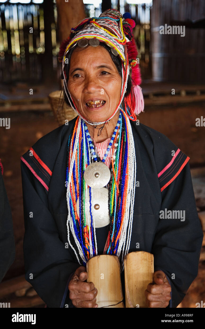 An Akha hilltribe woman in her ornate headdress performing a