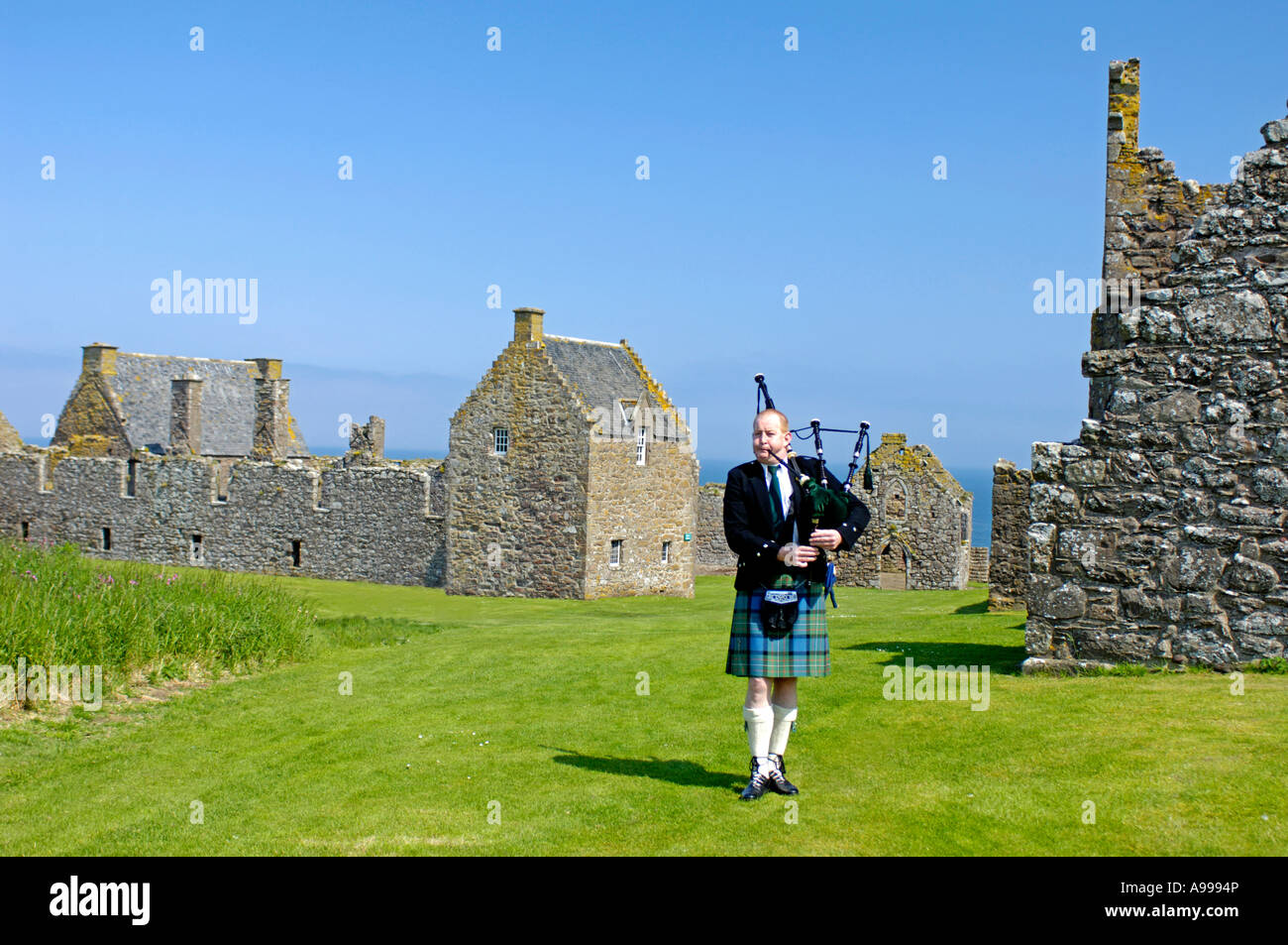 Wedding Piper at Dunnottar Castle on Clifftop overlooking the North Sea ...