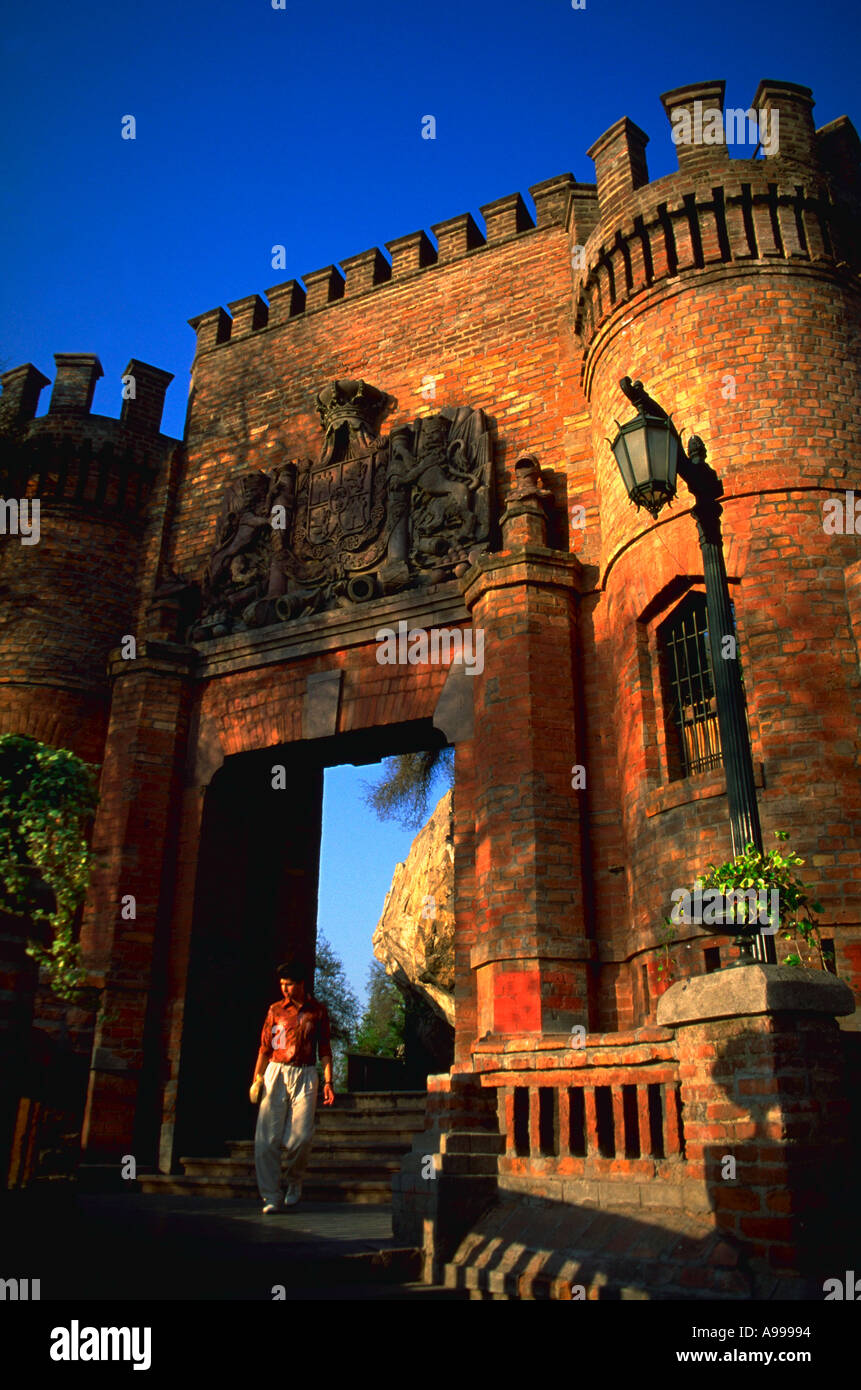 Young man strolls through the gate of a restored colonial fortress in Santa Lucia Hill Park in downtown Santiago Chile Stock Photo