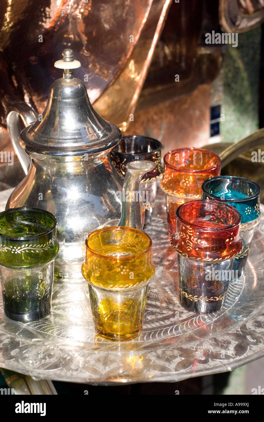 Brass and metalware shop displaying traditional Moroccan tea set in the main souq of Marrakesh Morocco Stock Photo