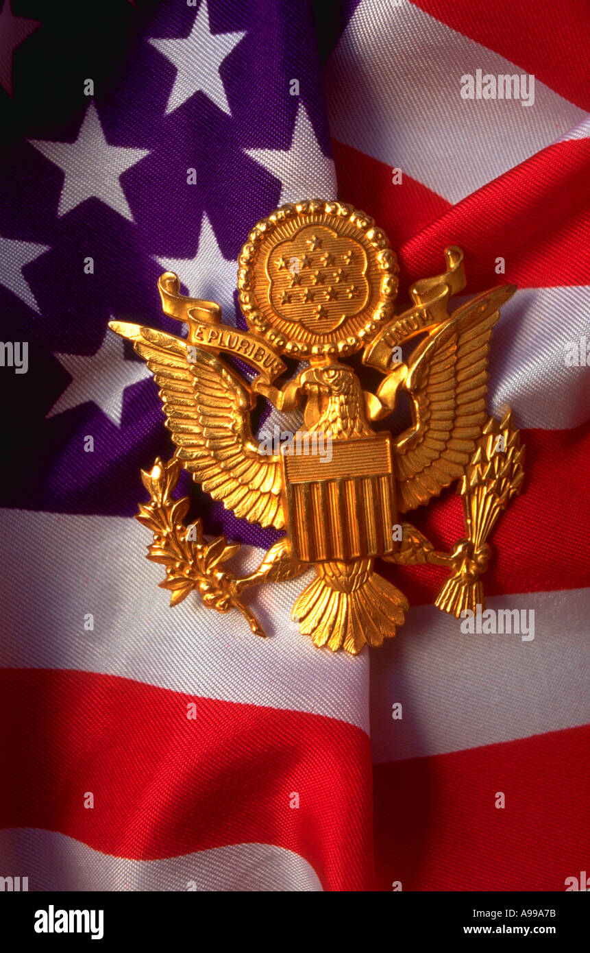 A gold rendering of The Great Seal of The United States with an America Flag in the background Stock Photo