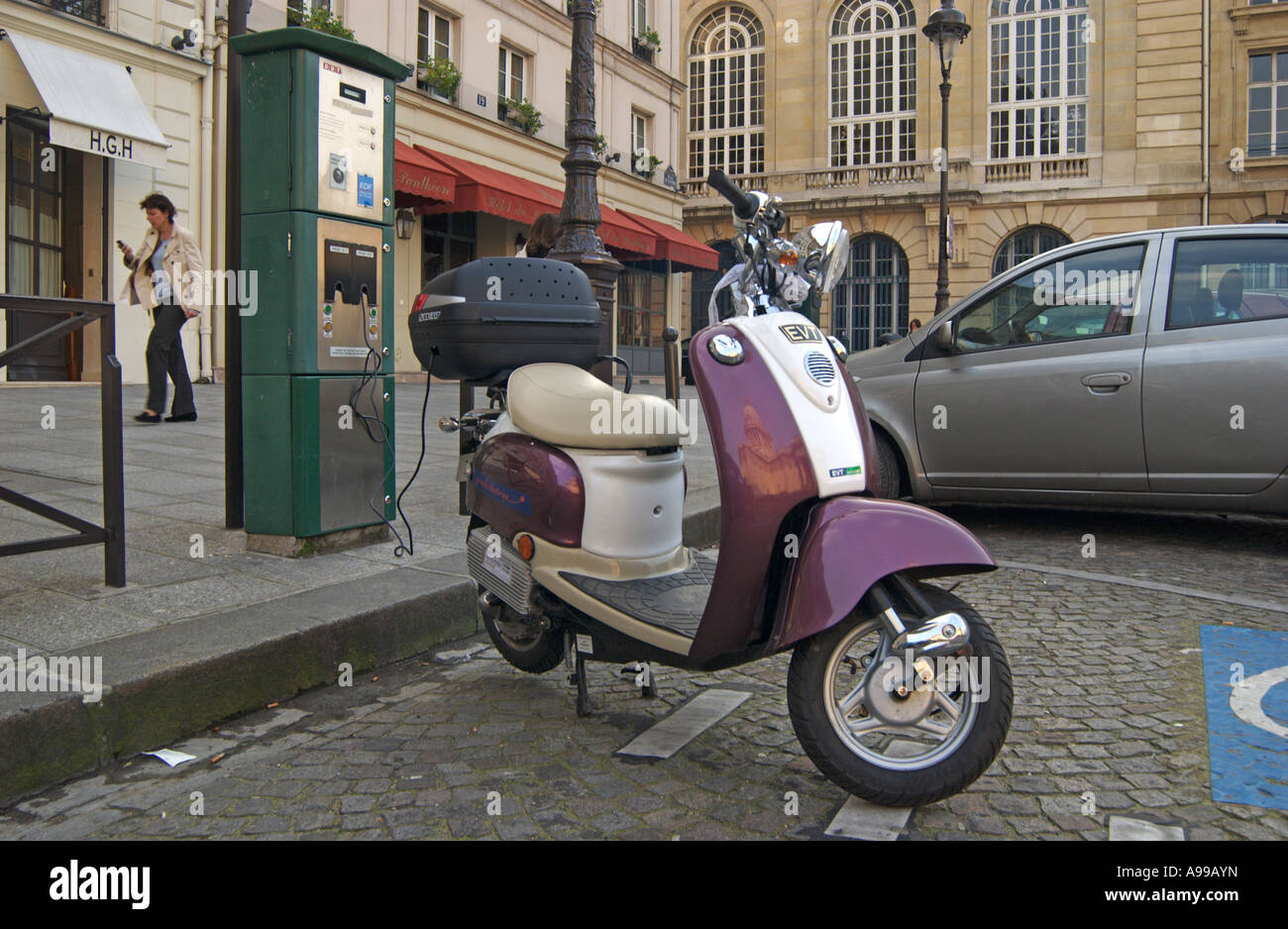Electric Scooter recharging in a reserve space in a Parisan Street., Paris, France, Europe Stock Photo