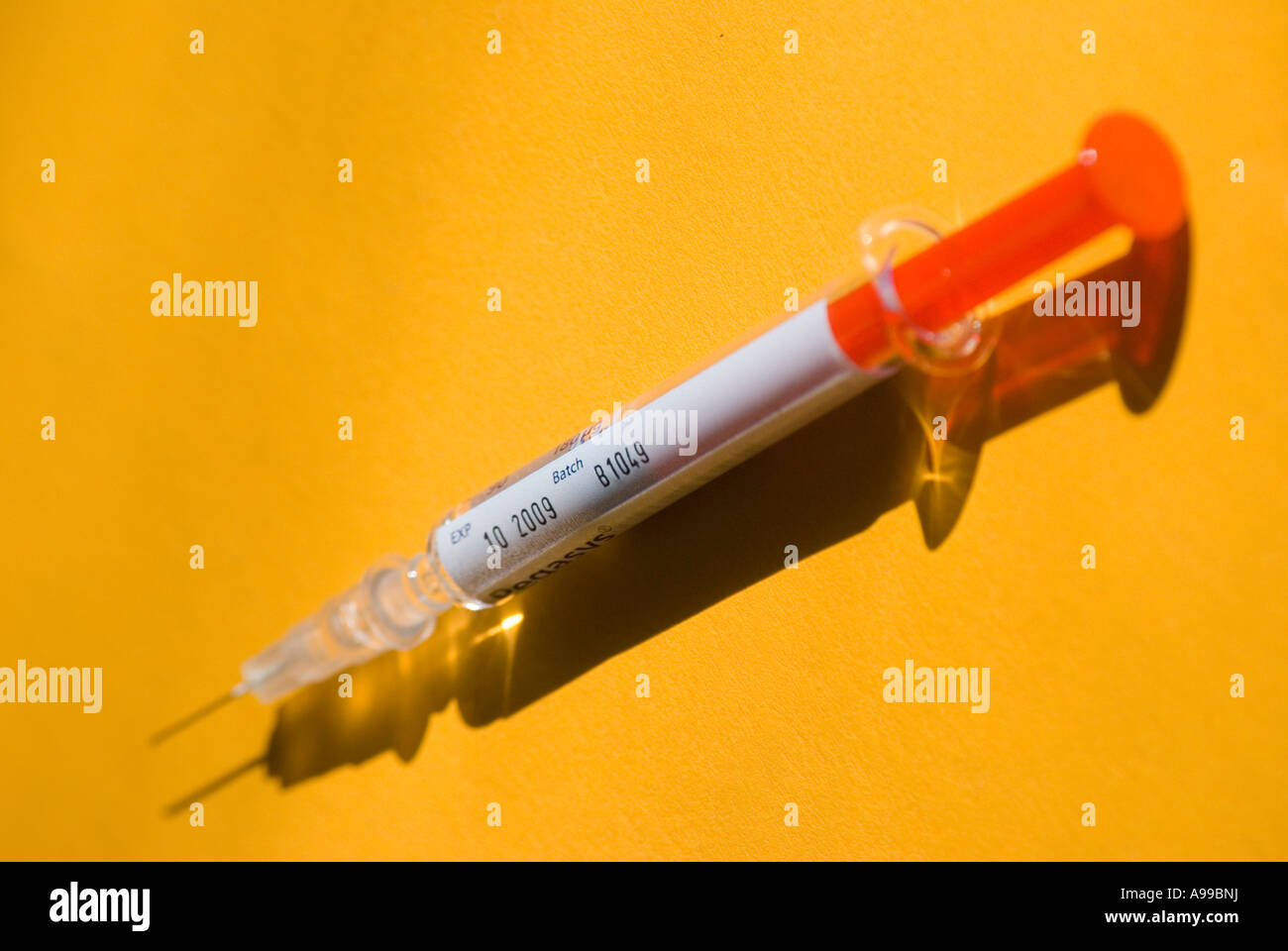 An hypodermic syringe of Interferon showing drug batch number and expiry date Stock Photo