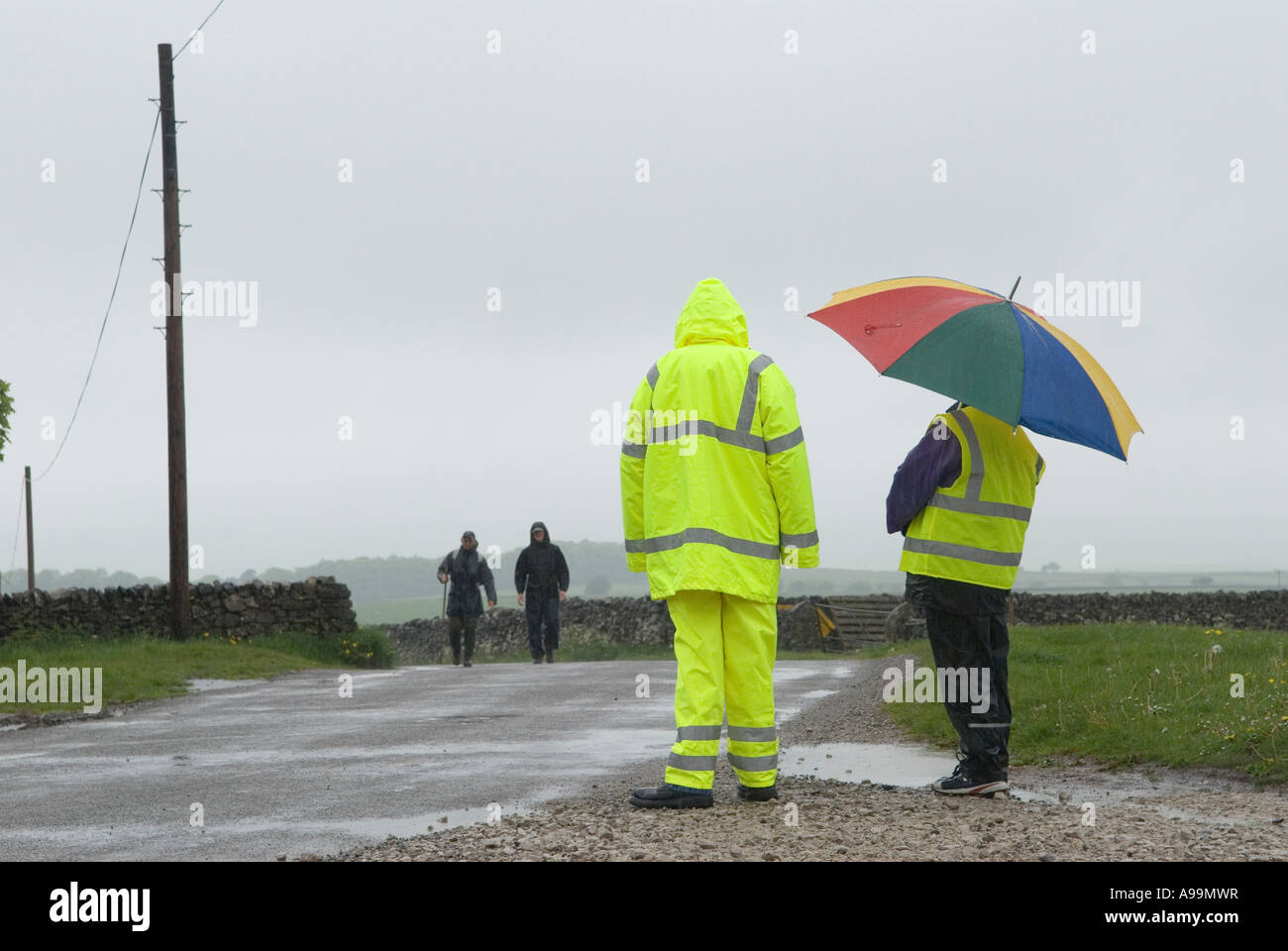 Sponsored charity walk in the Peak District, two Marshals watching the walkers, making sure all is OK. Derbyshire England 2007 2000s UK HOMER SYKES Stock Photo