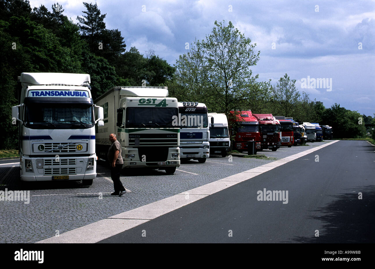 Lorries parked up in a service station near Cologne. HGV trucks are banned from using the motorways in Germany on Sundays Stock Photo