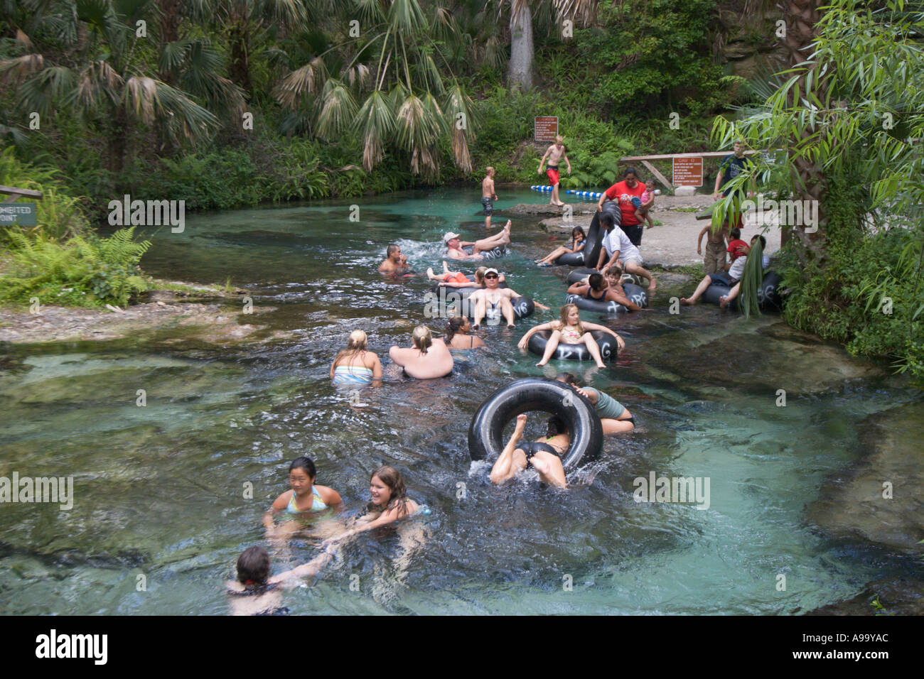 Families enjoy relaxing holiday swimming and floating down river on