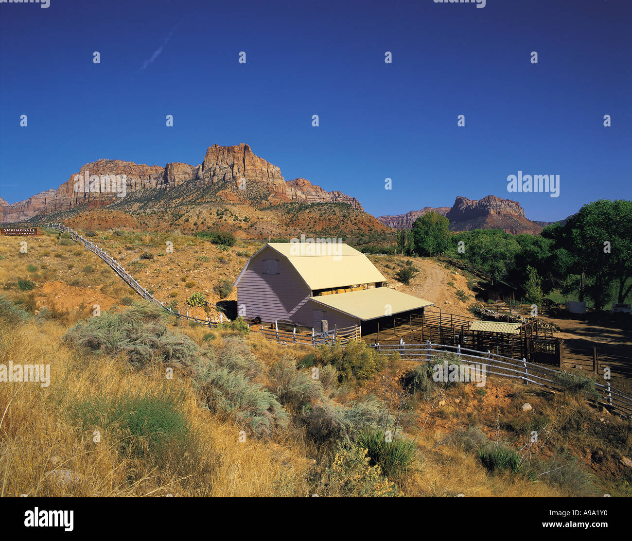 Ranch buildings and distant rock peaks at Springdale at the entrance to ...