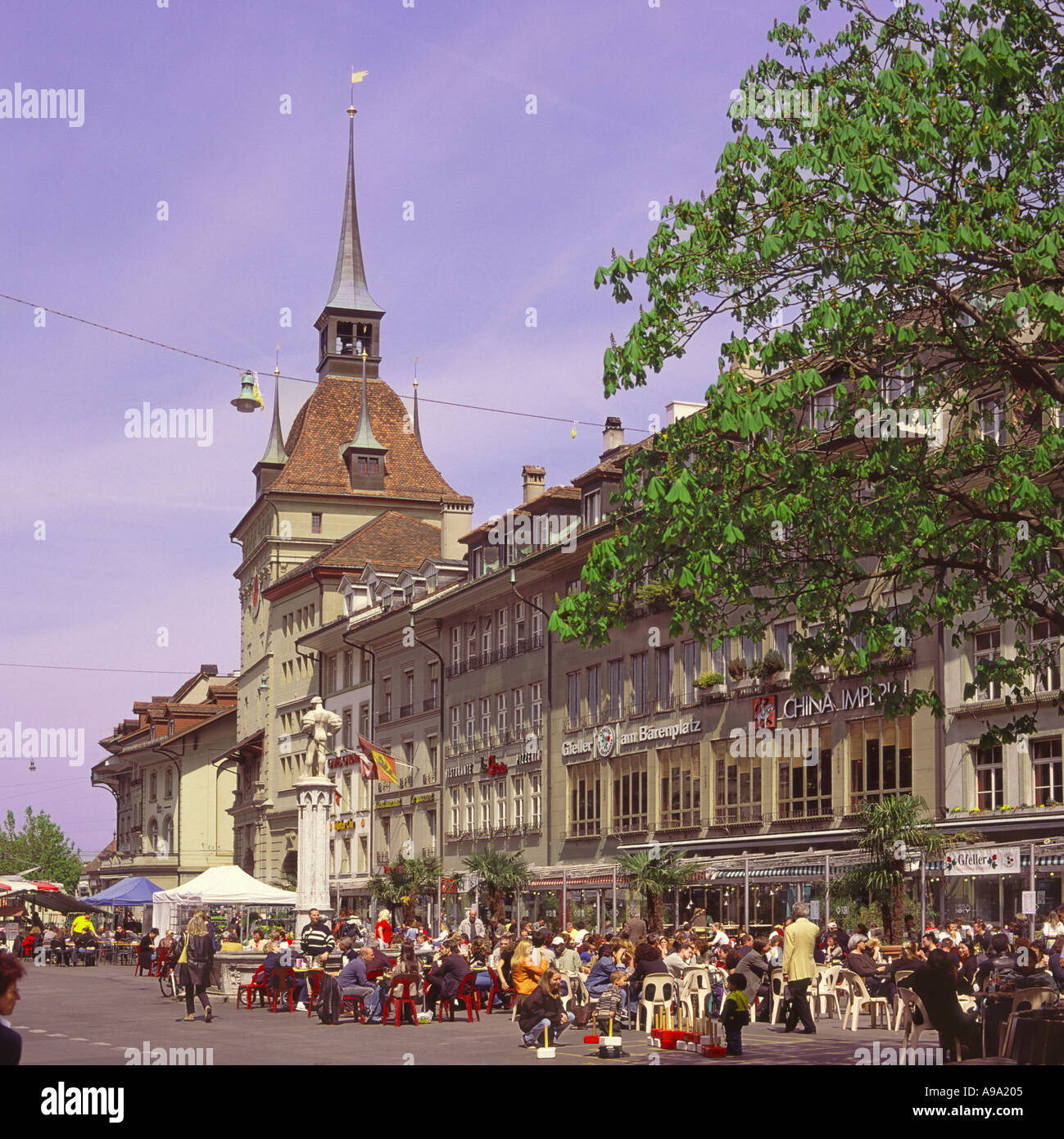 People tourists and city workers at lunchtime sitting outside at a café on Barenplatz in city center of Bern Switzerland Stock Photo
