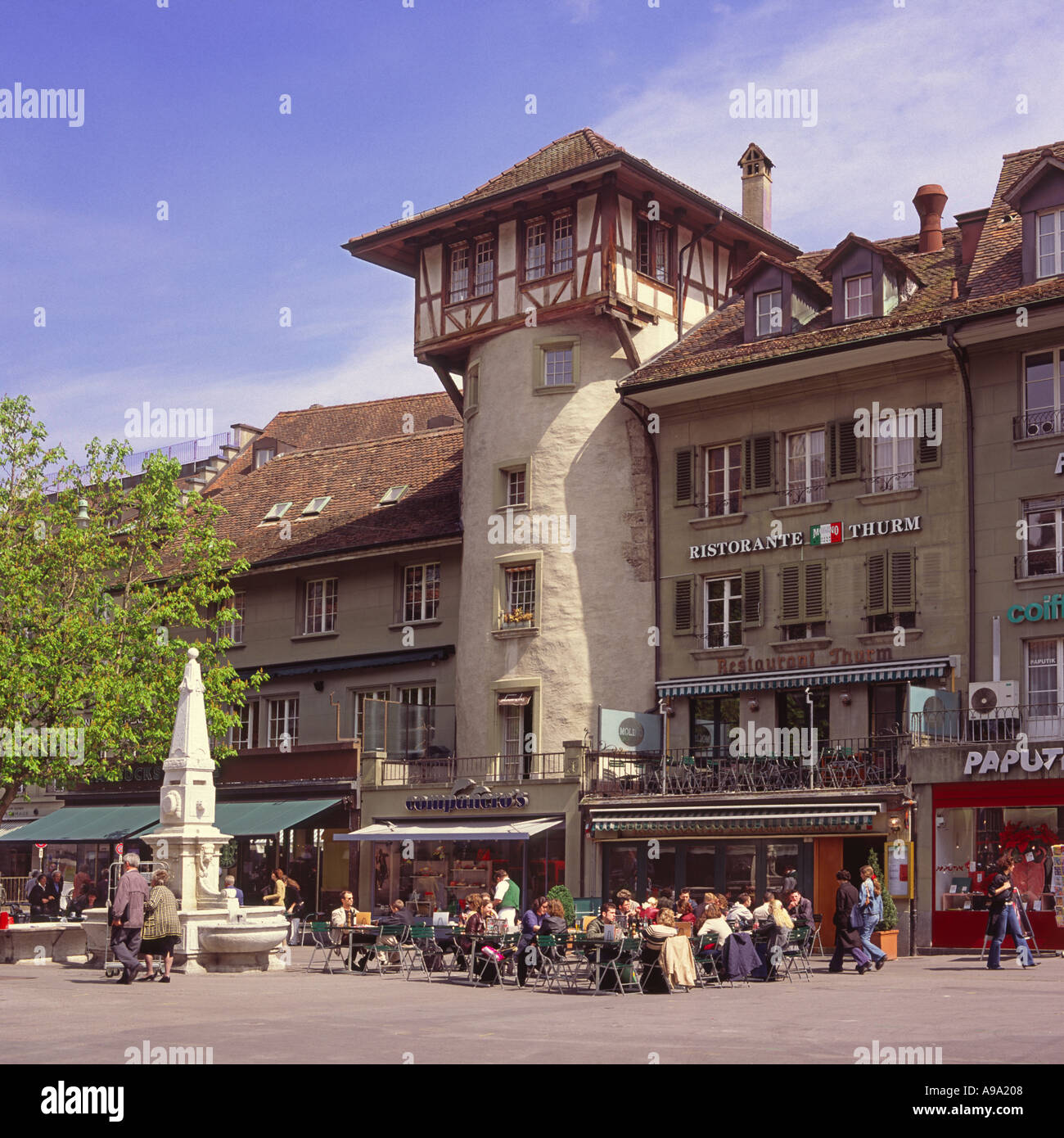 People sitting outside at a café on the sidewalk of Waisenhausplatz in the city center of Bern Switzerland Stock Photo