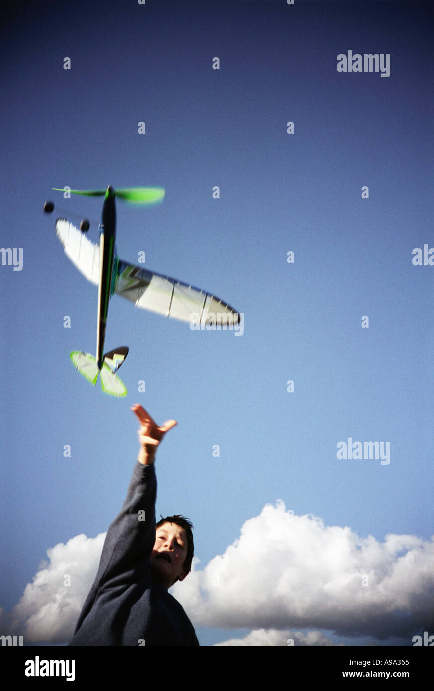 Boy flying model aeroplane Stock Photo