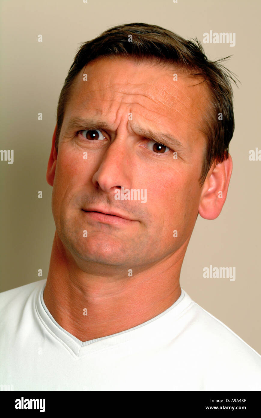 portrait of man in 30s looking confused Stock Photo