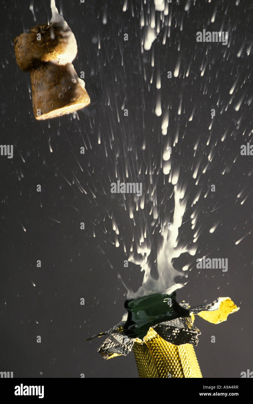 CHAMPAGNE BOTTLE CORK POPPING ON PLAIN BLACK BACKGROUND Stock Photo Alamy