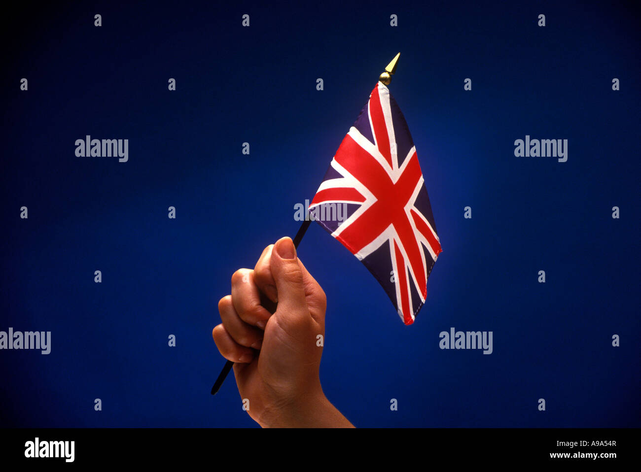 WOMANS HAND HOLDING UP BRITISH FLAG Stock Photo