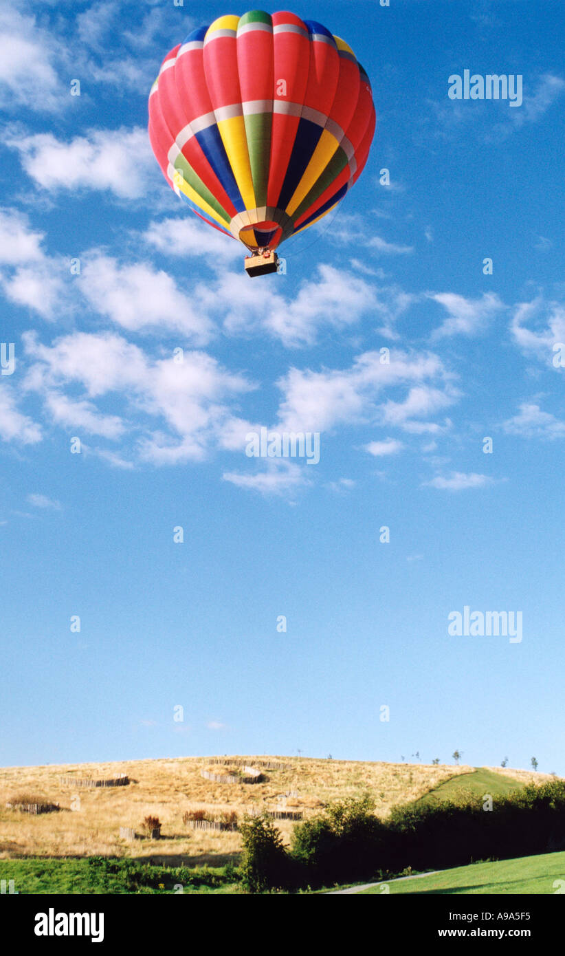 Hot Air balloon launch, multicoloured balloon rising over yellow corn ...