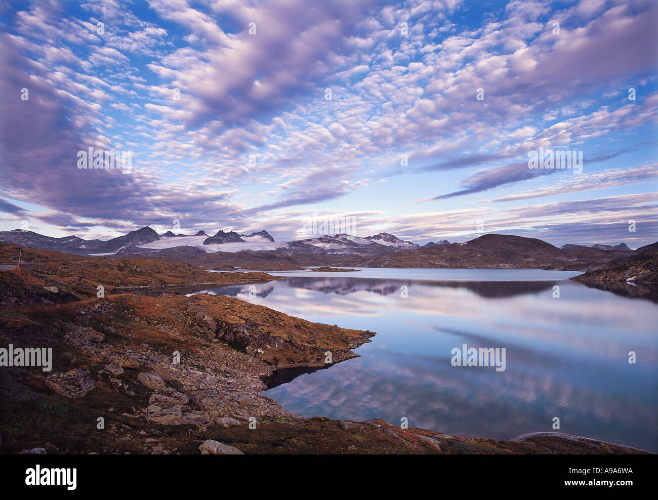 Early morning sky with mackerel clouds over the mountains and lakes of