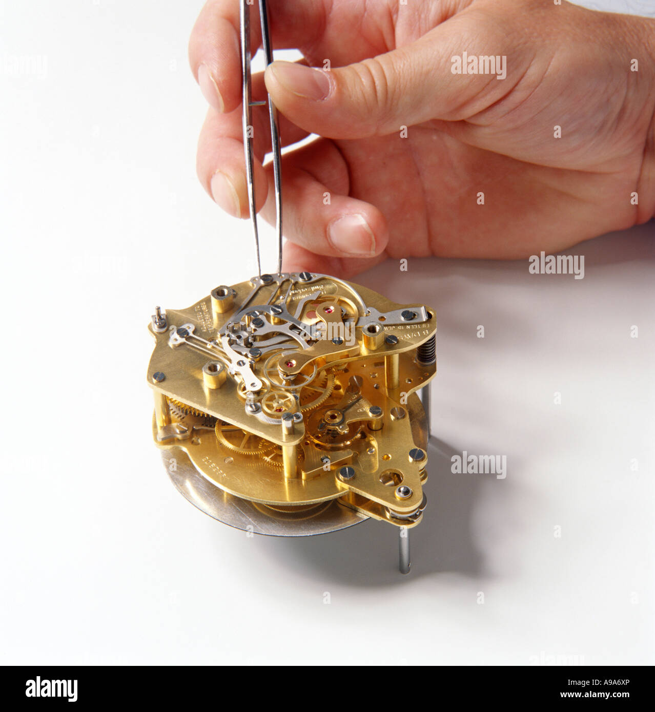 Technician works on a clock mechanism Stock Photo Alamy