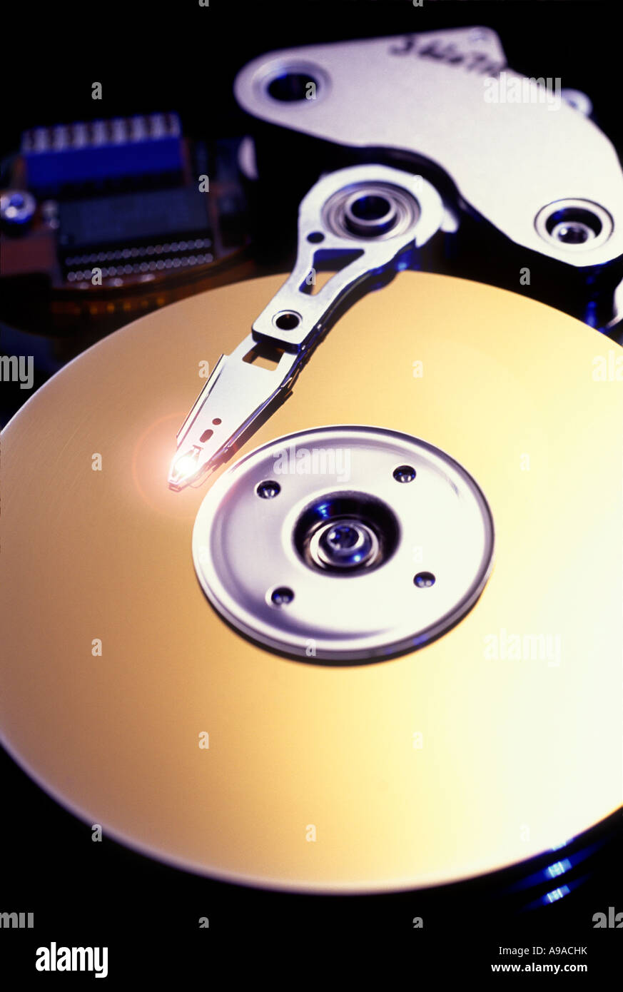 CLOSE UP OF ARMATURE AND DISC OF PERSONAL COMPUTER HARD DRIVE Stock