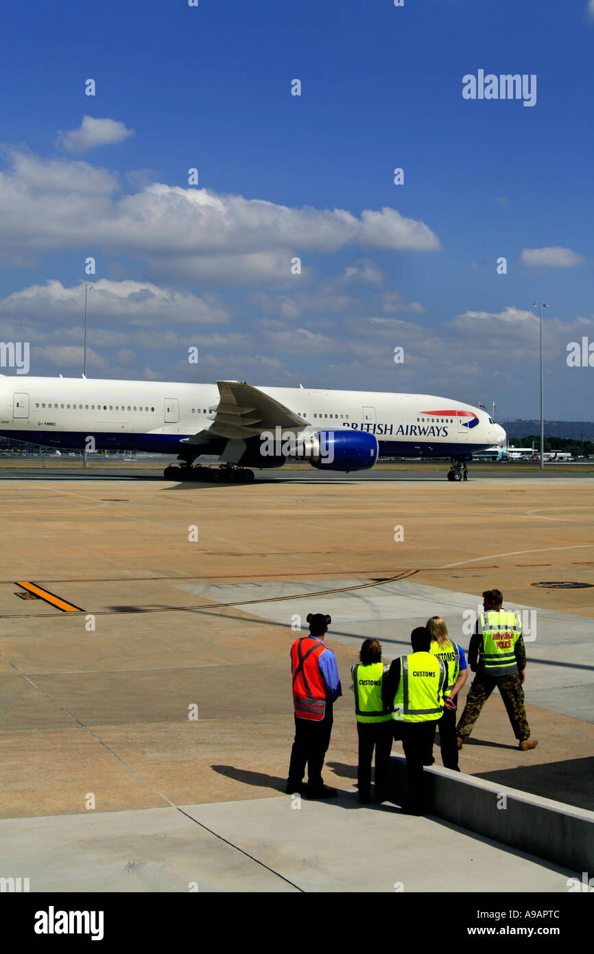Customs staff watch British Airways Jumbo Jet Stock Photo Alamy